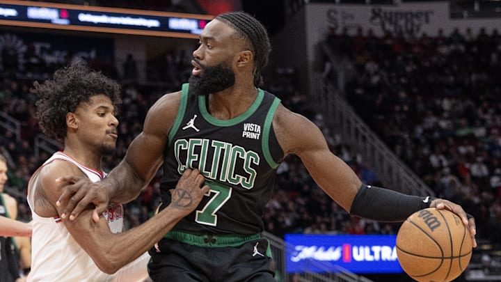 Jan 21, 2024; Houston, Texas, USA;  Boston Celtics guard Jaylen Brown (7) dribbles against Houston Rockets guard Jalen Green (4) in the second half at Toyota Center. Mandatory Credit: Thomas Shea-Imagn Images