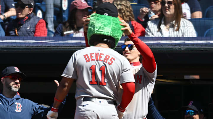 Boston Red Sox left fielder Jarren Duran (16) puts the Wally the Green Monster head on designated hitter Rafael Devers (11) after Devers hit a home run during the sixth inning against the Cleveland Guardians at Progressive Field on April 27.