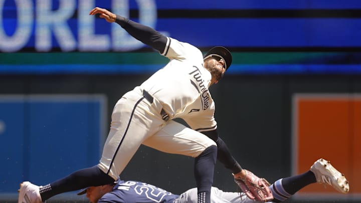 Jul 6, 2025; Minneapolis, Minnesota, USA; Minnesota Twins second baseman Willi Castro (50) tags out Tampa Bay Rays left fielder Jake Mangum (28) on a stolen base attempt in the second inning at Target Field. Mandatory Credit: Bruce Kluckhohn-Imagn Images