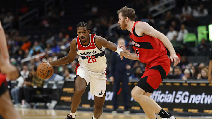 Oct 11, 2024; Washington, District of Columbia, USA; Washington Wizards forward Alex Sarr (20) drives to the basket as Toronto Raptors center Jakob Poeltl (19) in the second quarter at Capital One Arena. Mandatory Credit: Geoff Burke-Imagn Images