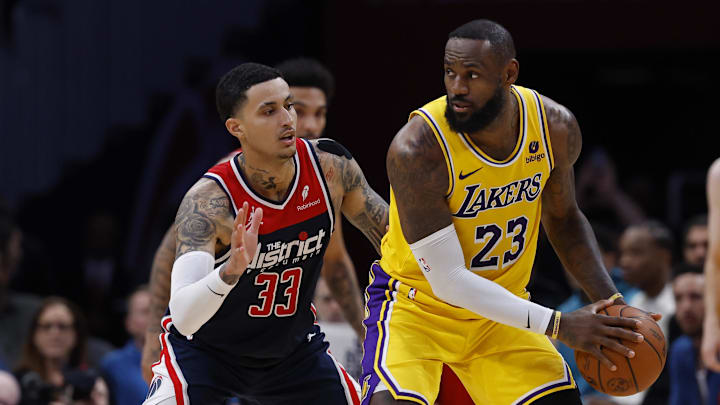 Apr 3, 2024; Washington, District of Columbia, USA; Los Angeles Lakers forward LeBron James (23) holds the ball as Washington Wizards forward Kyle Kuzma (33) defends at Capital One Arena. Mandatory Credit: Geoff Burke-Imagn Images