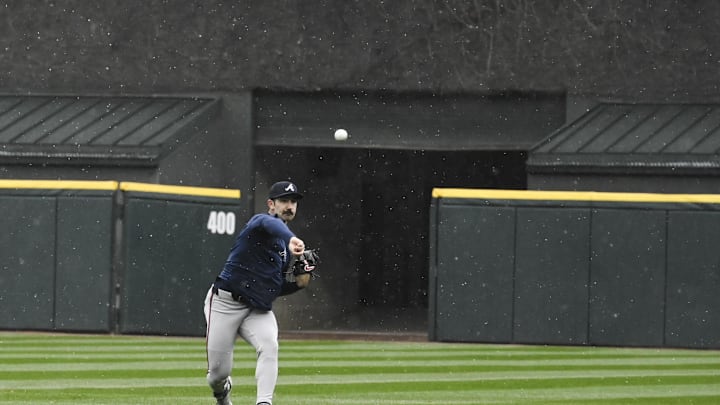 Atlanta Braves starting pitcher Spencer Strider (99) warms up in the rain before a game against the Chicago White Sox at Guaranteed Rate Field. The game was cancelled due to inclement weather in 2024.