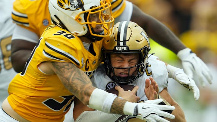 Sep 21, 2024; Columbia, Missouri, USA; Vanderbilt Commodores quarterback Diego Pavia (2) is sacked by Missouri Tigers linebacker Chuck Hicks (30) during the first half at Faurot Field at Memorial Stadium. Sep 21, 2024; Columbia, Missouri, USA; Vanderbilt Commodores quarterback Diego Pavia (2) is sacked by Missouri Tigers linebacker Chuck Hicks (30) during the first half at Faurot Field at Memorial Stadium.