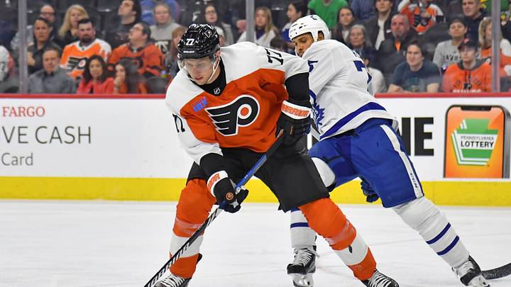 Mar 14, 2024; Philadelphia, Pennsylvania, USA; Philadelphia Flyers defenseman Erik Johnson (77) moves past Toronto Maple Leafs right wing Ryan Reaves (75) during the second period at Wells Fargo Center. Mandatory Credit: Eric Hartline-USA TODAY Sports