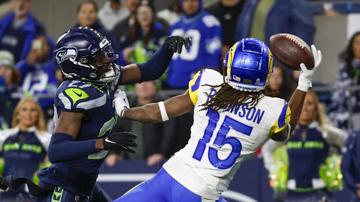 Nov 3, 2024; Seattle, Washington, USA; Los Angeles Rams wide receiver Demarcus Robinson (15) catches a game-winning touchdown pass against Seattle Seahawks cornerback Riq Woolen (27) during overtime at Lumen Field. Mandatory Credit: Joe Nicholson-Imagn Images