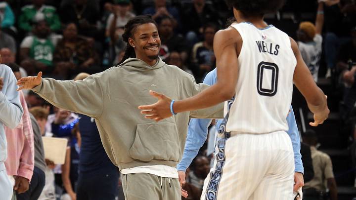 Mar 20, 2026; Memphis, Tennessee, USA; Memphis Grizzlies guard Ja Morant (left) reacts with forward Jaylen Wells (0) during a timeout during the fourth quarter against the Boston Celtics at FedExForum. Mandatory Credit: Petre Thomas-Imagn Images