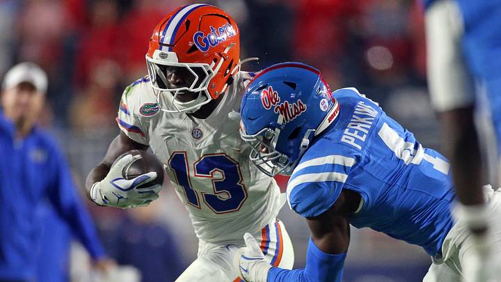 Florida Gators running back Jadan Baugh runs the ball as Mississippi Rebels linebacker Suntarine Perkins makes the tackle during the second quarter at Vaught-Hemingway Stadium. Mandatory Credit: Petre Thomas-Imagn Images