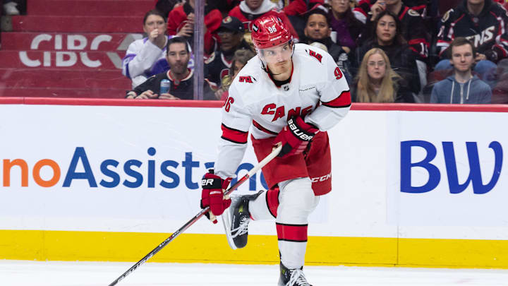 Apr 17, 2025; Ottawa, Ontario, CAN; Carolina Hurricanes center Jack Roslovic (96) shoots the puck in the second period against the Ottawa Senators at the Canadian Tire Centre. Mandatory Credit: Marc DesRosiers-Imagn Images