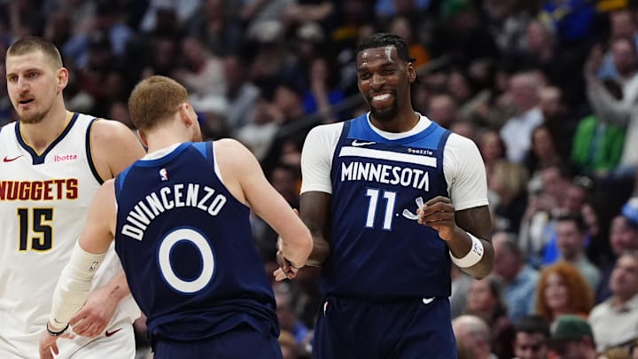 Mar 12, 2025; Denver, Colorado, USA; Minnesota Timberwolves center Naz Reid (11) celebrates his three point score with guard Donte DiVincenzo (0) in the second half against the Denver Nuggets at Ball Arena. Mandatory Credit: Ron Chenoy-Imagn Images