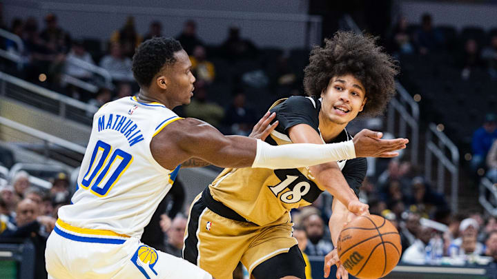 Dec 14, 2025; Indianapolis, Indiana, USA;  Washington Wizards forward Kyshawn George (18) passes the ball while Indiana Pacers guard/forward Bennedict Mathurin (00) defends in the second half at Gainbridge Fieldhouse. Mandatory Credit: Trevor Ruszkowski-Imagn Images