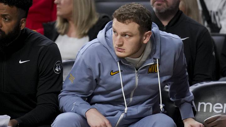 Feb 2, 2025; Cincinnati, Ohio, USA;  West Virginia Mountaineers’ Tucker DeVries watches from the bench in the game against the Cincinnati Bearcats in the second half at Fifth Third Arena. Mandatory Credit: Aaron Doster-Imagn Images