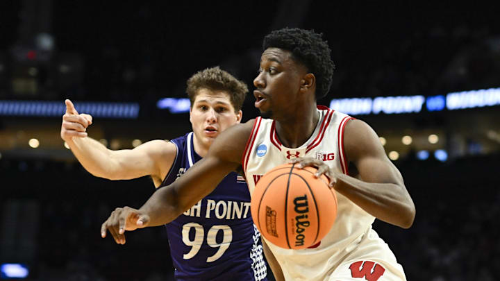 Mar 19, 2026; Portland, OR, USA; Wisconsin Badgers guard John Blackwell (25) drives to the basket against High Point Panthers guard Chase Johnston (99) during the second half of a first round game of the men's 2026 NCAA Tournament at Moda Center. Mandatory Credit: Troy Wayrynen-Imagn Images