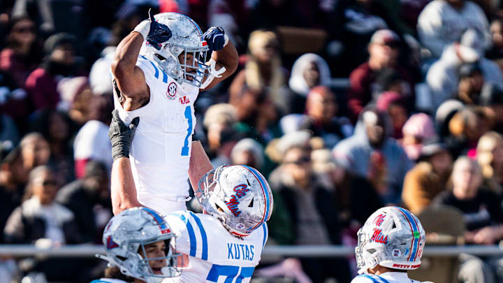 Ole Miss offensive lineman Patrick Kutas (75) lifts up wide receiver De'Zhaun Stribling (1) after scoring during a college football game between Mississippi State and Ole Miss at Davis Wade Stadium in Starkville, Miss., on Friday, Nov. 28, 2025. Ole Miss defeated Mississippi State 38-19 in the Egg Bowl.