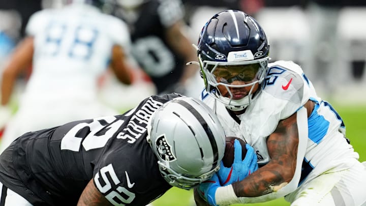Las Vegas Raiders outside linebacker Elandon Roberts tackles Tennessee Titans running back Tony Pollard.