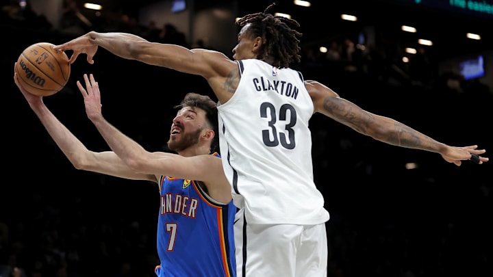 Mar 18, 2026; Brooklyn, New York, USA; Brooklyn Nets center Nic Claxton (33) blocks a shot by Oklahoma City Thunder center Chet Holmgren (7) during the second quarter at Barclays Center. Mandatory Credit: Brad Penner-Imagn Images