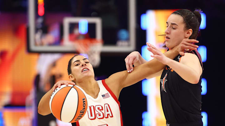 Jul 20, 2024; Phoenix, AZ, USA; USA Women's National Team guard Kelsey Plum (5) controls the ball as Team WNBA guard Caitlin Clark (22) defends during the second half at Footprint Center. Mandatory Credit: Mark J. Rebilas-Imagn Images