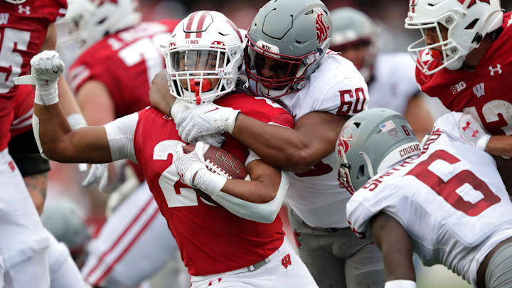 Wisconsin Badgers running back Isaac Guerendo (20) is tackled by Washington State Cougars David Gusta (60)during their football game Saturday, September 10, 2022, at Camp Randall in Madison, Wis. Dan Powers/USA TODAY NETWORK-Wisconsin