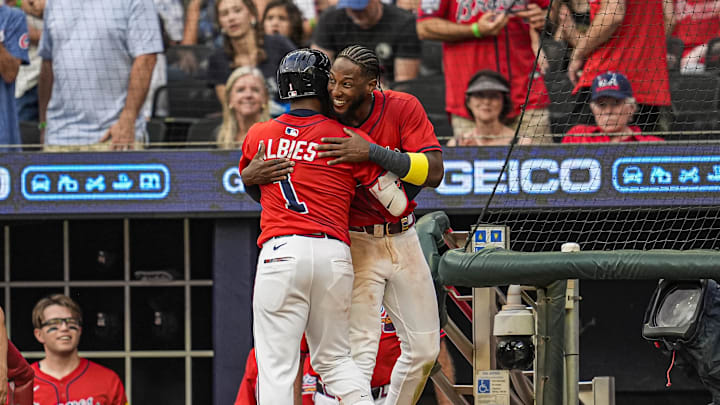 Jul 18, 2025; Cumberland, Georgia, USA; Atlanta Braves second baseman Ozzie Albies (1) reacts with left fielder Jurickson Profar (7) after hitting a three run home run against the New York Yankees during the third inning at Truist Park. Mandatory Credit: Dale Zanine-Imagn Images