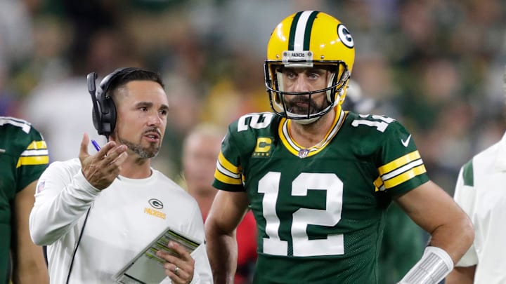 Green Bay Packers head coach Matt LaFleur talks with quarterback Aaron Rodgers (12) in between quarters against the Chicago Bears during their game on Sep 18, 2022, in Green Bay, Wisconsin.