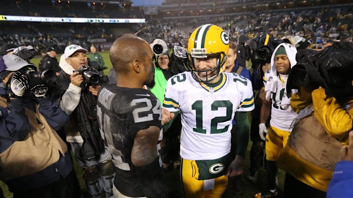  Green Bay Packers quarterback Aaron Rodgers (12) and Oakland Raiders free safety Charles Woodson (24) greet each other 