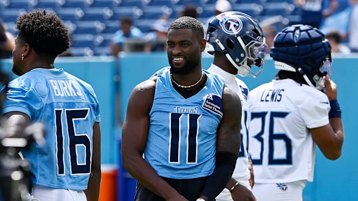 Tennessee Titans wide receiver Van Jefferson (11) puts his gloves on before stretching during “Back Together Weekend” training camp practice at Nissan Stadium Saturday, July 26, 2025, in Nashville, Tenn.