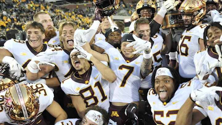 Oct 21, 2023; Iowa City, Iowa, USA; The Minnesota Golden Gophers hold the Floyd of Rosedale trophy after the game against the Iowa Hawkeyes at Kinnick Stadium. Mandatory Credit: Jeffrey Becker-Imagn Images