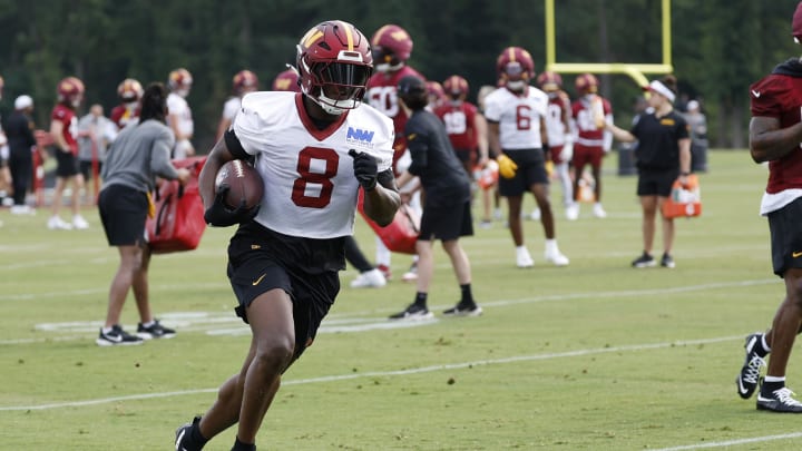 Jul 25, 2024; Ashburn, VA, USA; Washington Commanders running back Brian Robinson Jr. (8) carries a ball during drills on day two of Commanders training camp at OrthoVirginia Training Center at Commanders Park. Mandatory Credit: Geoff Burke-USA TODAY Sports Jul 25, 2024; Ashburn, VA, USA; Washington Commanders running back Brian Robinson Jr. (8) carries a ball during drills on day two of Commanders training camp at OrthoVirginia Training Center at Commanders Park. Mandatory Credit: Geoff Burke-USA TODAY Sports