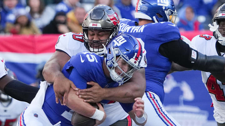 Nov 24, 2024; East Rutherford, New Jersey, USA; New York Giants quarterback Tommy DeVito (15) is sacked by Tampa Bay Buccaneers defensive tackle Vita Vea (50) during the first half at MetLife Stadium. M Nov 24, 2024; East Rutherford, New Jersey, USA; New York Giants quarterback Tommy DeVito (15) is sacked by Tampa Bay Buccaneers defensive tackle Vita Vea (50) during the first half at MetLife Stadium. M