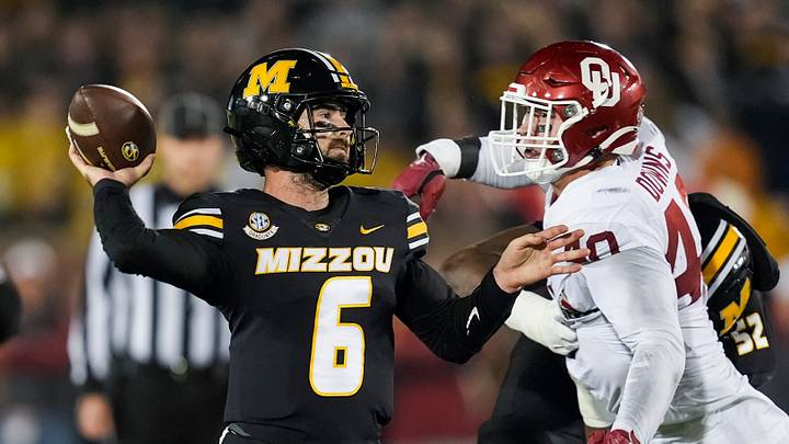 Nov 9, 2024; Columbia, Missouri, USA; Missouri Tigers quarterback Drew Pyne (6) throws a pass against Oklahoma Sooners defensive lineman Ethan Downs (40) during the second half at Faurot Field at Memorial Stadium. Mandatory Credit: Jay Biggerstaff-Imagn Images