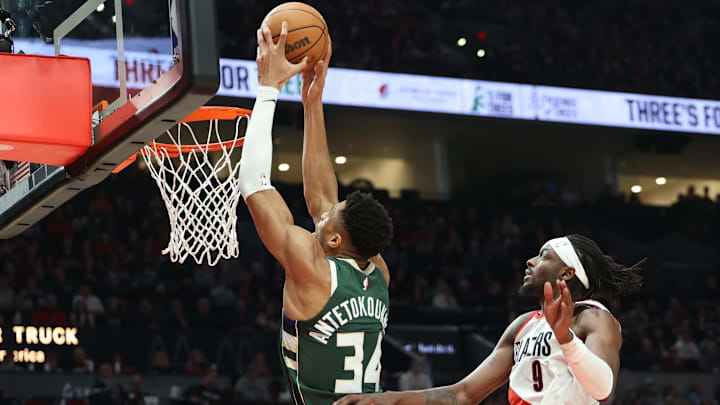 Milwaukee Bucks forward Giannis Antetokounmpo dunks the ball over Portland Trail Blazers forward Jerami Grant in the first half at Moda Center. Mandatory Credit: Jaime Valdez-Imagn Images