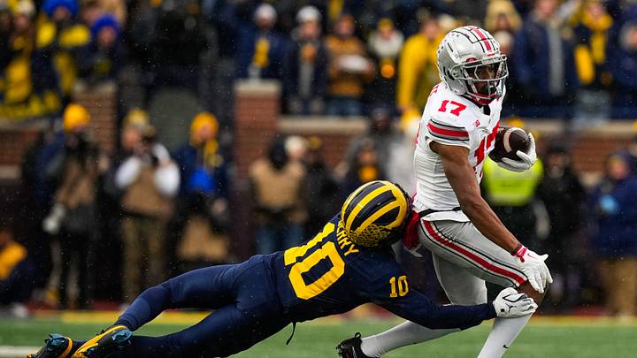 Ohio State Buckeyes wide receiver Carnell Tate (17) runs the ball against Michigan Wolverines defensive back Zeke Berry (10) in the first half of the NCAA football game at Michigan Stadium on Saturday, Nov. 29, 2025 in Ann Arbor, Michigan.