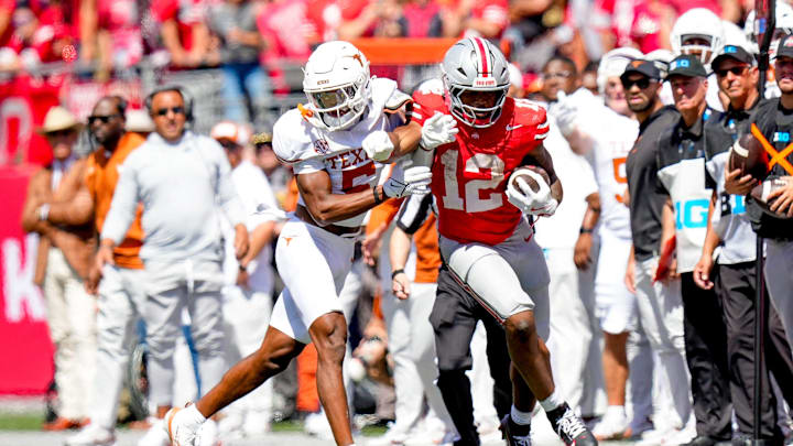 Ohio State Buckeyes running back CJ Donaldson (12) runs the ball against Texas Longhorns defensive back Malik Muhammad (5) in the second half at Ohio Stadium on Saturday, Aug. 30, 2025 in Columbus, Ohio. Ohio State Buckeyes running back CJ Donaldson (12) runs the ball against Texas Longhorns defensive back Malik Muhammad (5) in the second half at Ohio Stadium on Saturday, Aug. 30, 2025 in Columbus, Ohio.