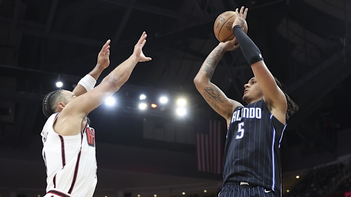 Orlando Magic forward Paolo Banchero (5) shoots the ball as Houston Rockets forward Dillon Brooks (9) defends during the third quarter at Toyota Center.
