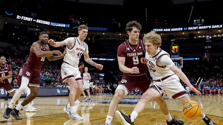 Mar 19, 2026; Oklahoma City, OK, USA; Saint Mary's (CA) Gaels guard Liam Campbell (33) dribbles the ball against Texas A&M Aggies guard Ruben Dominguez (9) during a first round game of the men's 2026 NCAA Tournament at Paycom Center. Mandatory Credit: Alonzo Adams-Imagn Images