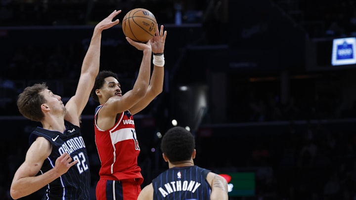 Mar 6, 2024; Washington, District of Columbia, USA; Washington Wizards guard Jordan Poole (13) shoots the ball as Orlando Magic forward Franz Wagner (22) defends in the second half at Capital One Arena. Mandatory Credit: Geoff Burke-Imagn Images