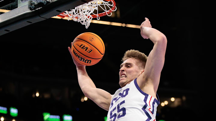 Mar 11, 2026; Kansas City, MO, USA; TCU Horned Frogs guard Tanner Toolson (55) rebounds during the first half against the Oklahoma State Cowboys at T-Mobile Center. Mandatory Credit: William Purnell-Imagn Images