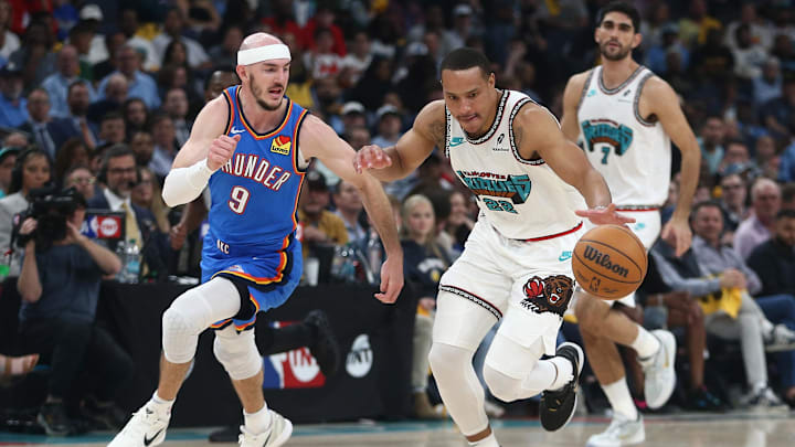 Apr 24, 2025; Memphis, Tennessee, USA; Memphis Grizzlies guard Desmond Bane (22) dribbles as Oklahoma City Thunder guard Alex Caruso (9) defends during the second quarter during game three for the first round of the 2025 NBA Playoffs at FedExForum. Mandatory Credit: Petre Thomas-Imagn Images