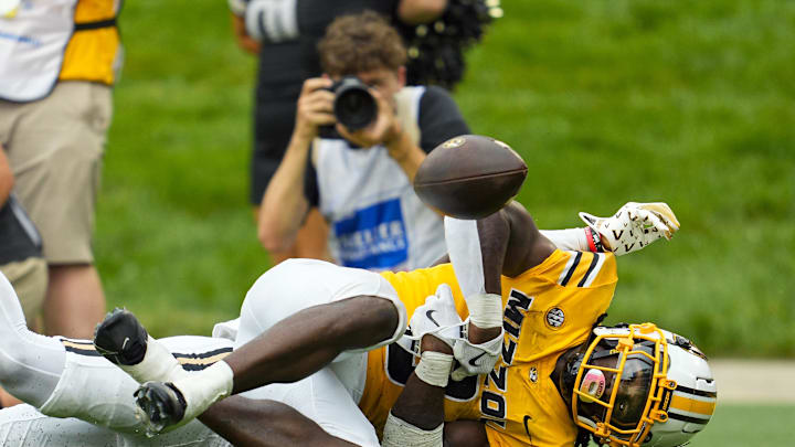 Sep 21, 2024; Columbia, Missouri, USA; Missouri Tigers running back Nate Noel (8) loses the ball after being tackled by Vanderbilt Commodores cornerback Martel Hight (25) during the second half at Faurot Field at Memorial Stadium. Mandatory Credit: Jay Biggerstaff-Imagn Images