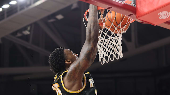 Feb 21, 2026; Fayetteville, Arkansas, USA; Missouri Tigers center Shawn Phillips Jr (15) dunks the ball during the second half against the Arkansas Razorbacks at Bud Walton Arena. Arkansas won 94-86. Mandatory Credit: Nelson Chenault-Imagn Images