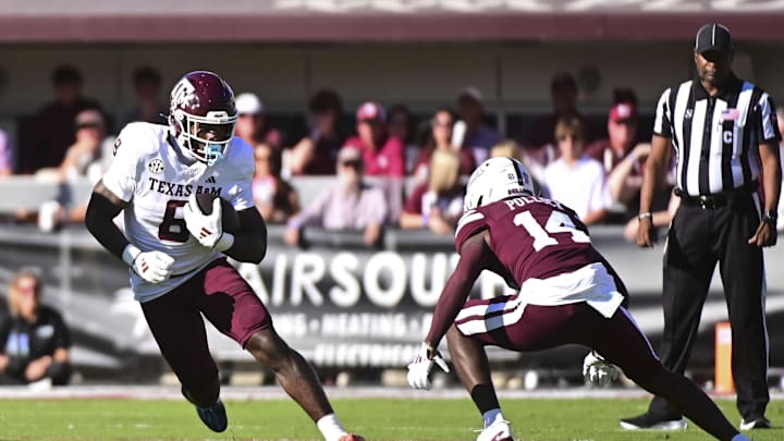 Oct 19, 2024; Starkville, Mississippi, USA; Texas A&M Aggies wide receiver Cyrus Allen (6) runs the ball against Mississippi State Bulldogs cornerback Brice Pollock (14) during the first quarter at Davis Wade Stadium at Scott Field. Mandatory Credit: Matt Bush-Imagn Images