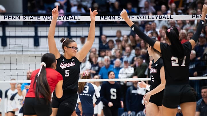 Nebraska players, including Rebekah Allick (5), celebrate a point in the first set of a Big Ten volleyball match against Penn State at Rec Hall on Friday, Nov. 29, 2024, in State College, Pa.