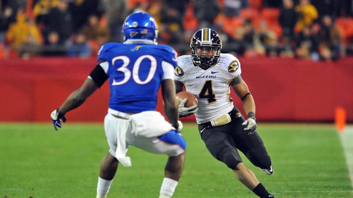 November 26, 2011; Kansas City, MO, USA; Missouri Tigers running back Kendial Lawrence (4) catches a pass as Kansas Jayhawks cornerback Anthony Davis (30) defends in the second half at Arrowhead Stadium. Missouri won 24-10.Mandatory Credit: Denny Medley-Imagn Images