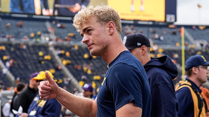 Michigan quarterback Davis Warren (16) waves at fans during warm up before the Texas game at Michigan Stadium in Ann Arbor on Saturday, September 7, 2024.