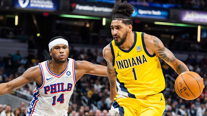 Jan 18, 2025; Indianapolis, Indiana, USA; Indiana Pacers forward Obi Toppin (1) dribbles the ball while Philadelphia 76ers guard Ricky Council IV (14) defends in the first half at Gainbridge Fieldhouse. Mandatory Credit: Trevor Ruszkowski-Imagn Images
