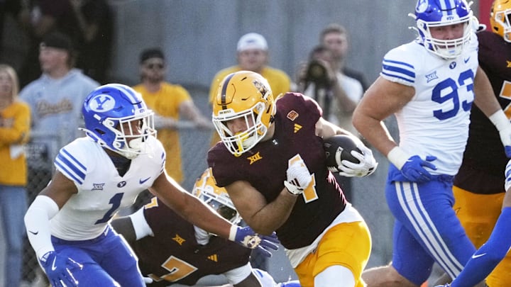 Arizona State running back Cam Skattebo (4) carries the ball during Big 12 conference play against BYU at Mountain America Stadium on Nov. 23, 2024. Arizona State running back Cam Skattebo (4) carries the ball during Big 12 conference play against BYU at Mountain America Stadium on Nov. 23, 2024.