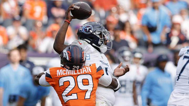 Sep 7, 2025; Denver, Colorado, USA; Denver Broncos cornerback Ja'Quan McMillian (29) hits Tennessee Titans quarterback Cam Ward (1) causing a fumble in the second half at Empower Field at Mile High. Mandatory Credit: Isaiah J. Downing-Imagn Images Sep 7, 2025; Denver, Colorado, USA; Denver Broncos cornerback Ja'Quan McMillian (29) hits Tennessee Titans quarterback Cam Ward (1) causing a fumble in the second half at Empower Field at Mile High. Mandatory Credit: Isaiah J. Downing-Imagn Images