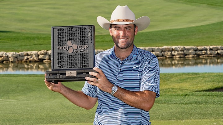 May 4, 2025; McKinney, Texas, USA; Scottie Scheffler poses with the winner's trophy during the final round of the THE CJ CUP Byron Nelson golf tournament. Scheffler won with a score of 31-under par for the tournament. Mandatory Credit: Raymond Carlin III-Imagn Images