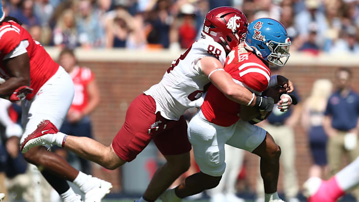 Oct 11, 2025; Oxford, Mississippi, USA; Washington State Cougars defensive end Isaac Terrell (88) forces Mississippi Rebels quarterback Trinidad Chambliss (6) to fumble during the second quarter at Vaught-Hemingway Stadium. Mandatory Credit: Petre Thomas-Imagn Images