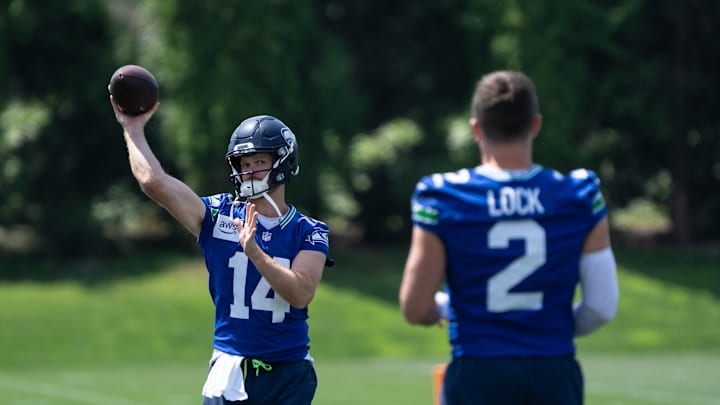 Jun 11, 2025; Renton, WA, USA; Seattle Seahawks quarterback Sam Darnold (14) passes the ball to quarterback Drew Lock (2) during mini-camp at Virginia Mason Athletic Center. 