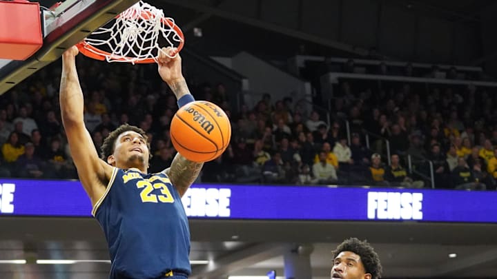 Feb 11, 2026; Evanston, Illinois, USA; Michigan Wolverines forward Yaxel Lendeborg (23) dunks the ball on Northwestern Wildcats forward Arrinten Page (22) during the first half at Welsh-Ryan Arena. Mandatory Credit: David Banks-Imagn Images